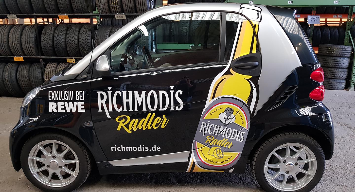 Autobeschriftung, Autobeklebung f&#252;r REWE Richmodis, Foliendruck, Folienplott und Autoverklebung